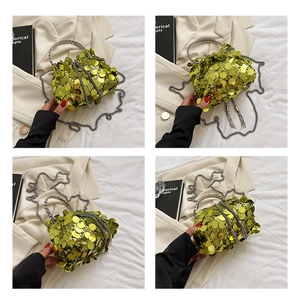 Detail of lime green sequined bucket bag with silver metal handle and fringe tassel