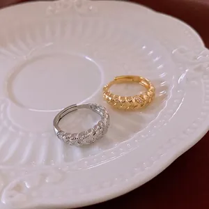 Vintage gold and silver twisted rings with cubic zirconia pavé in a woven design