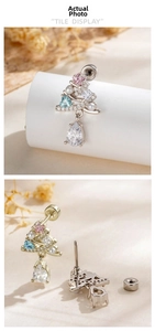Macro view of Christmas tree cartilage stud with colorful zircon and teardrop crystal