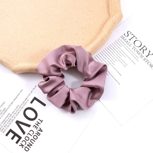 Detailed view of dusty rose silk satin oversized scrunchie texture and soft sheen