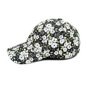 Detailed side view of floral baseball cap with white flower print on black fabric