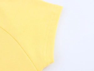 Macro shot of double-needle stitching on a bright yellow cotton t-shirt sleeve cuff