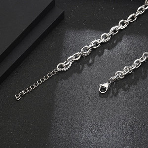 Detailed close-up of a silver chain necklace with zircon inlay and lobster clasp closure