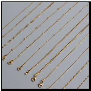 Close-up of various gold stainless steel chain styles including twist and snake links