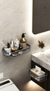 Detail of gray aluminum wall-mounted tissue holder and shelf set in a luxury bathroom