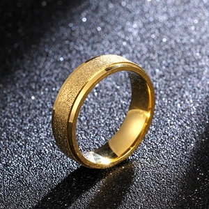 Minimalist 6mm gold titanium steel ring with matte frosted surface on black background