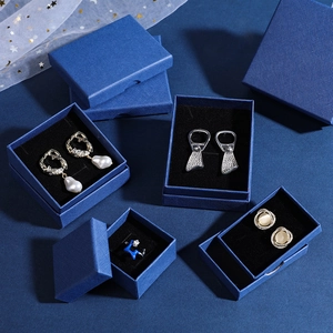 Deep blue textured jewelry gift box set with pearl earrings and enamel ring display