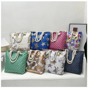 Collection of tote bags with nautical prints and thick rope handles on white display steps