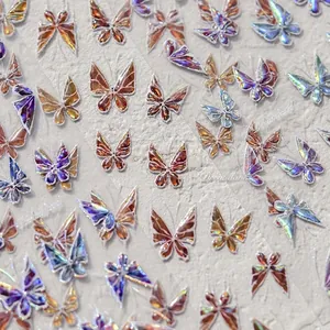 Macro shot of holographic butterfly nail art stickers with iridescent blue and purple gradients