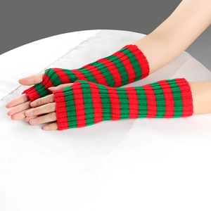 Detail of red and green striped knitted fingerless gloves with soft wool texture