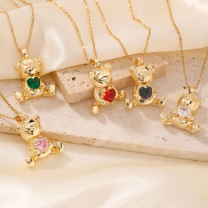 Golden bear pendant necklace set with colorful heart zircons on cream silk fabric