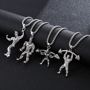 Silver dumbbell and bodybuilder necklaces for men on black textured background