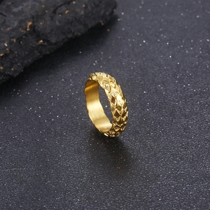 Macro shot of gold-plated stainless steel ring with dragon scale textured facets