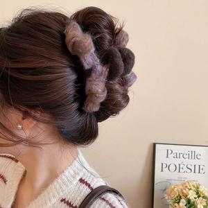 Macro shot of bicolour plush claw clip in dark brown and lilac on a model's hair