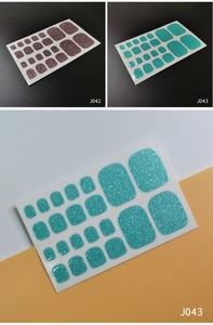 Macro detail of glitter toe nail stickers in lilac purple and lake blue glitter finish