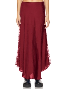 Detailed view of dark red satin skirt with delicate black lace trim on the side seam