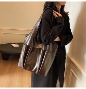Macro detail of dark brown retro PU leather tote bag featuring two large front patch pockets