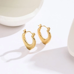 Minimalist gold U-shaped textured heart earrings for women on a white background