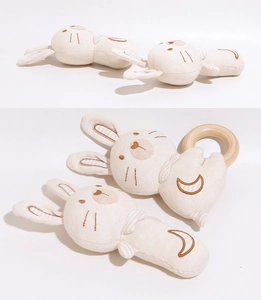 Detailed view of organic cotton baby rattle set with wooden ring and bunny embroidery