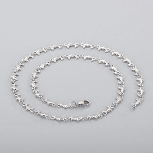 Detailed view of silver dolphin-shaped links on a high-quality stainless steel necklace