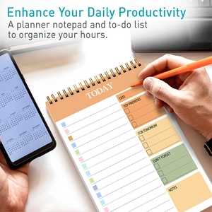 Daily schedule planner with color-coded task lists and priorities on a spiral notebook
