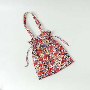 Floral print canvas tote bag with drawstring closure and colorful flower patterns