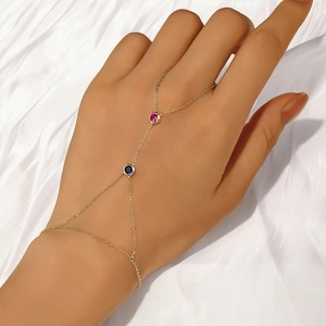 Close-up of gold S925 silver hand harness with pink and blue crystal gemstones