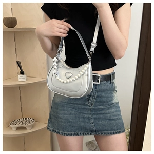 Silver mirror leather shoulder bag featuring heart embossing and pearl chain details