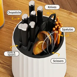 Rotating white kitchen knife holder with slots for cutlery, utensils, and scissors