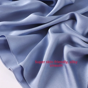 Close-up of misty blue chiffon shawl showing silky smooth texture and soft draped fabric
