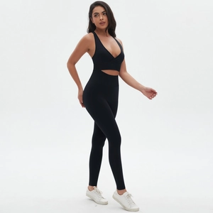 Detail view of black seamless yoga set featuring cross-back bra and high-waisted leggings