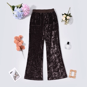 Detailed view of high-waist velvet wide-leg pants in dark brown with pleated texture