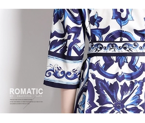 Detail of blue and white baroque print satin shirt dress with wide cuffs and waist tie
