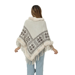 Women's knit poncho with faux fur collar, snowflake pattern, and tassel trim back view