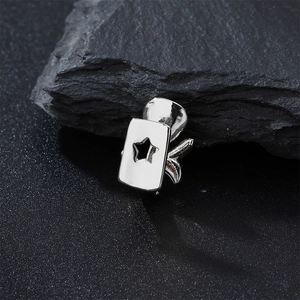 Macro view of silver hip hop single tooth grillz with star cutout on textured rock