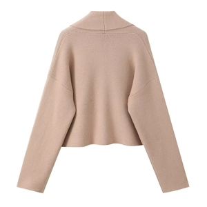 Detail of chunky knit texture and shawl collar on a pink short cardigan sweater