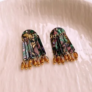 Vintage neo-Chinese style tassel earrings with colorful acetate texture on a ceramic tray