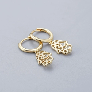 Macro view of gold S925 sterling silver hoop earrings with Hamsa Hand pendant charms