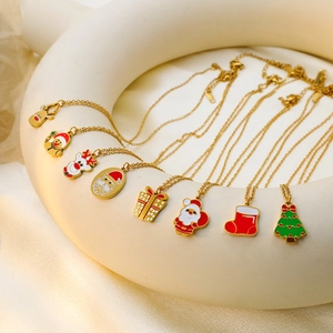 Close-up of golden Christmas necklaces with colorful enamel charms on a display stand