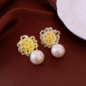 Elegant floral pearl drop earrings featuring yellow beaded flowers and round white pearls