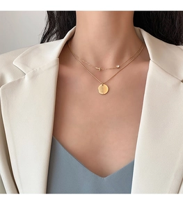 Detail of double-layered 18K gold-plated titanium necklace with S925 engraved pendant