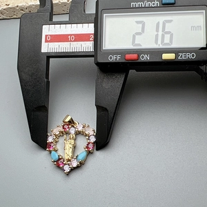 Detail view of heart pendant with multi-color zircons measuring 21.6mm in width