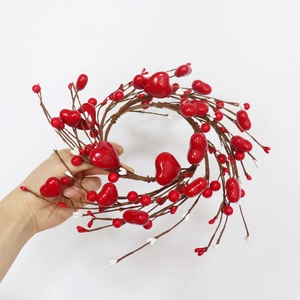 Detail of a heart-shaped red berry wreath with rustic rattan base for Valentine decor
