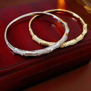 Detail of silver and gold bamboo-joint hinged bracelets with micro-pave cubic zirconia