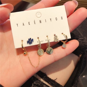 Macro view of a 6-piece gold earring set with colorful zircon and silver posts
