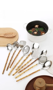 Macro view of 8-piece stainless steel kitchen tool set with natural bamboo handles