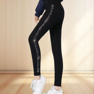 Women's black thermal leggings featuring sparkling LOVE rhinestone stripes on sides