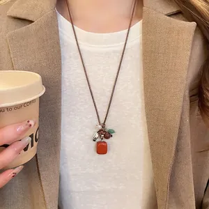 Bohemian style necklace with stone and wood beads on a brown cord worn with a blazer