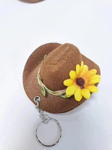 Miniature brown felt cowboy hat keychain with yellow sunflower detail and silver ring