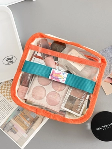 Transparent PVC makeup bag with orange trim and teal handle for travel toiletries